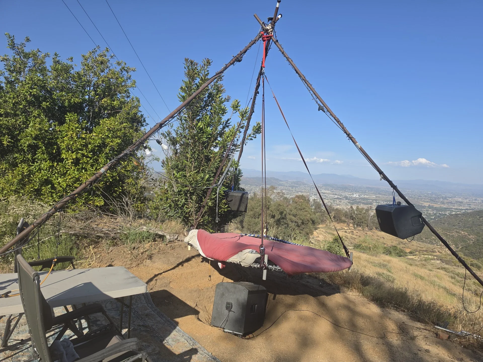 The swing by day, cushions on the bed, the valley opening beyond
